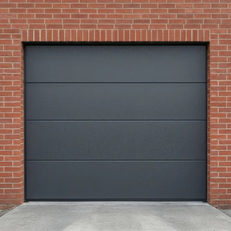 Antraciete sectionale garagedeur in rode bakstenen gevel door Montage Service Limburg